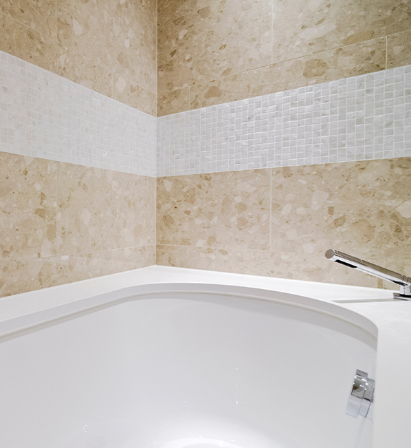A photo of tub and travertine tile