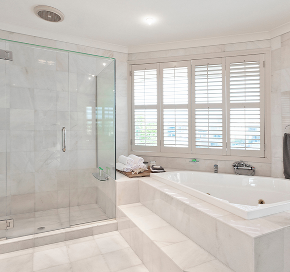 Photo of bathroom with white bathtub and tiles